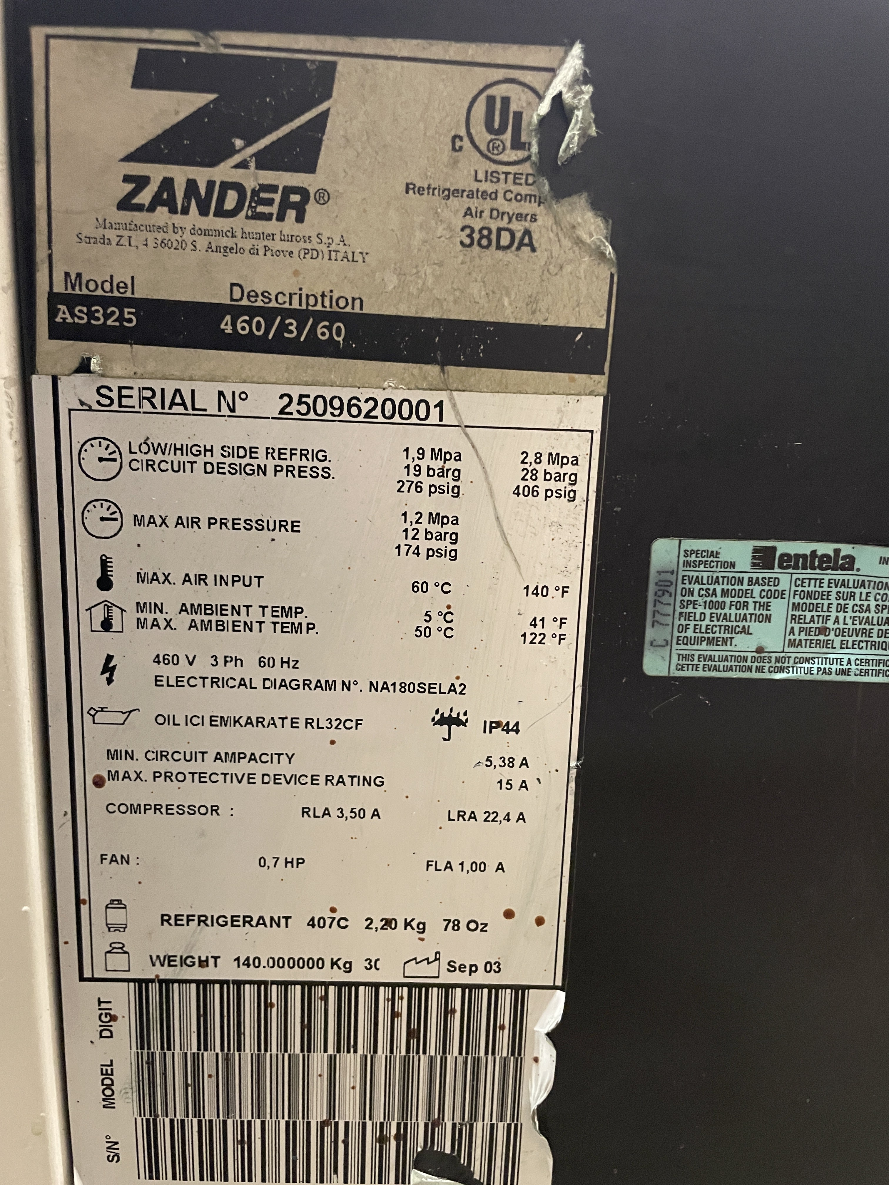 Close-up of a Zander air dryer model AS325 label showing technical specifications, ratings, and serial number, with some wear and partial tearing at the top.