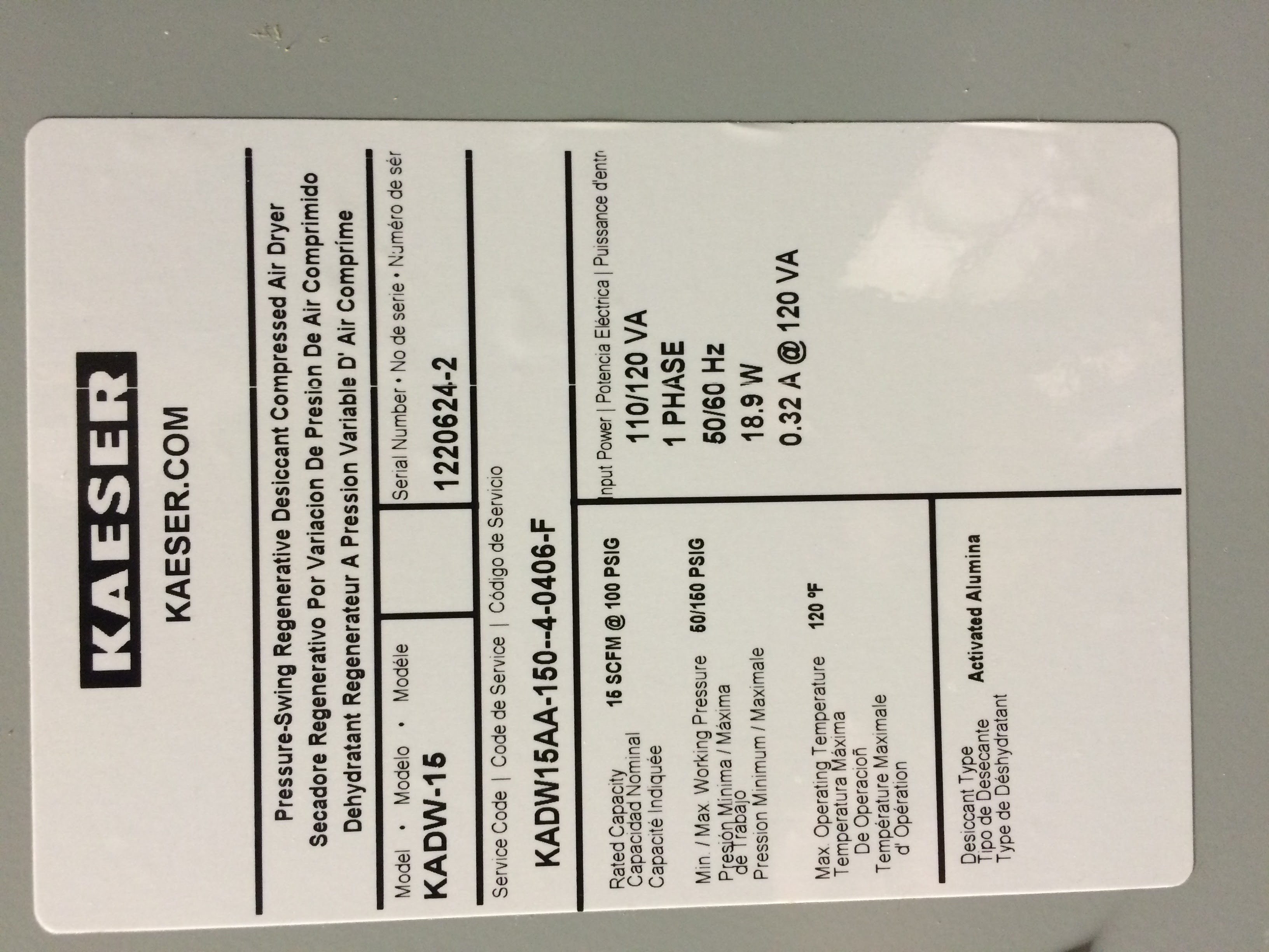 Label on a KAESER compressed air dryer showing model, serial number, electrical data, rated capacity, and service information in English and Spanish.